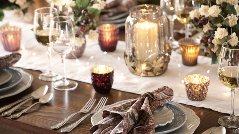 Table settings with votive candles as centerpieces