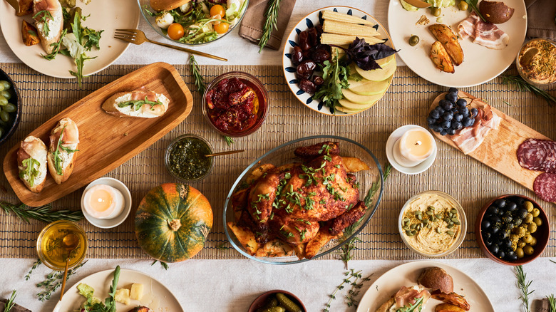 Top-down view of Thanksgiving table with roasted turkey and sides