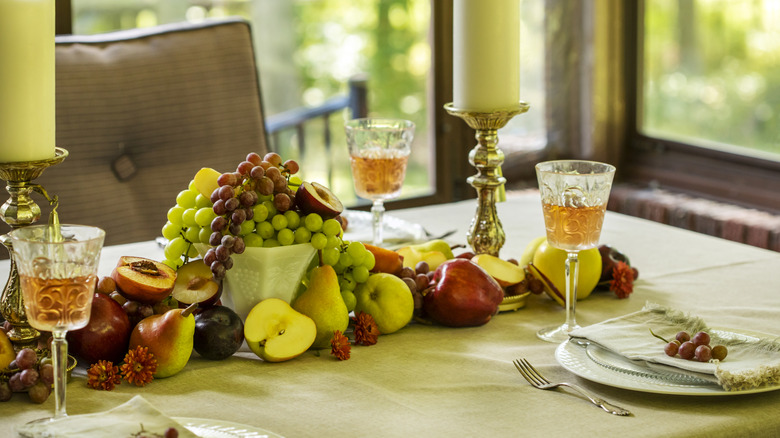 Table set with fresh fruit piled in the center as the centerpiece