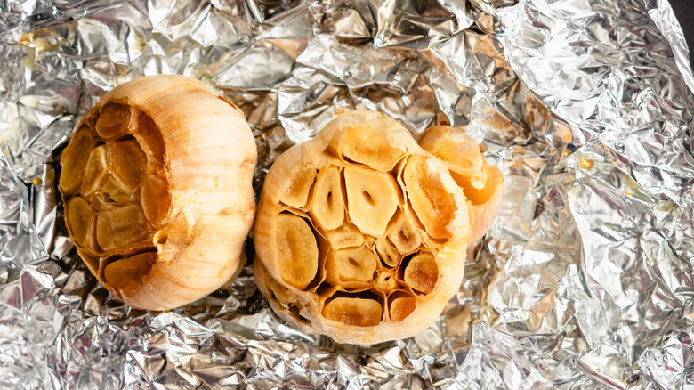 Roasted halved garlic cloves in tin foil