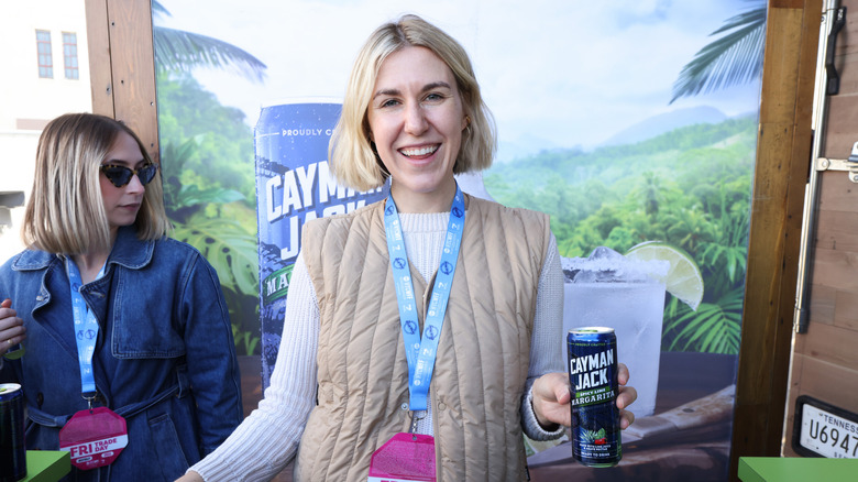 Instagram chef Justine Doiron smiling and holding a canned cocktail