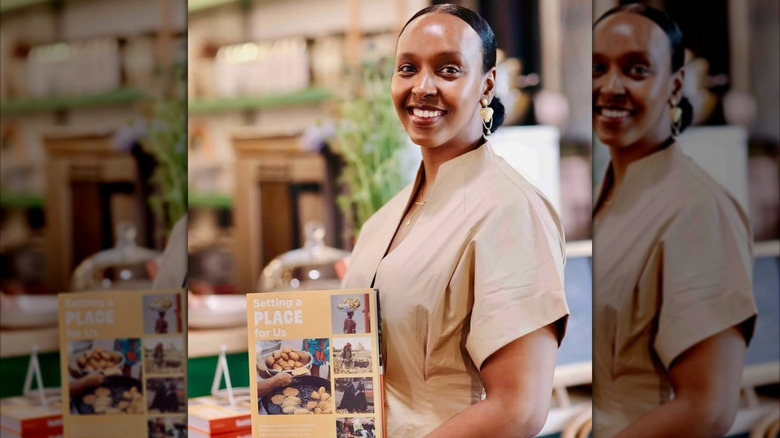 Chef Hawa Hassan holding her cookbook