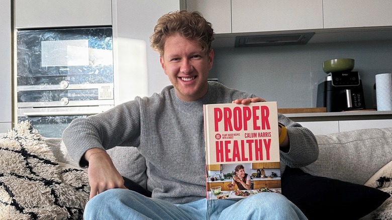 Instagram cook Calum Harris holding his cookbook