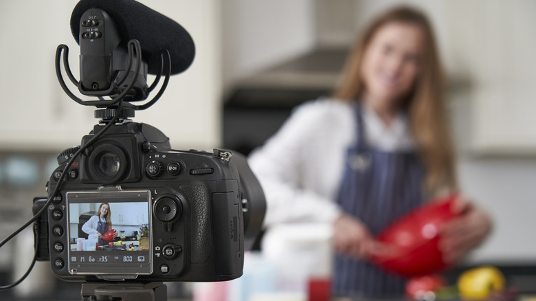 Woman filming a cooking video in her kitchen