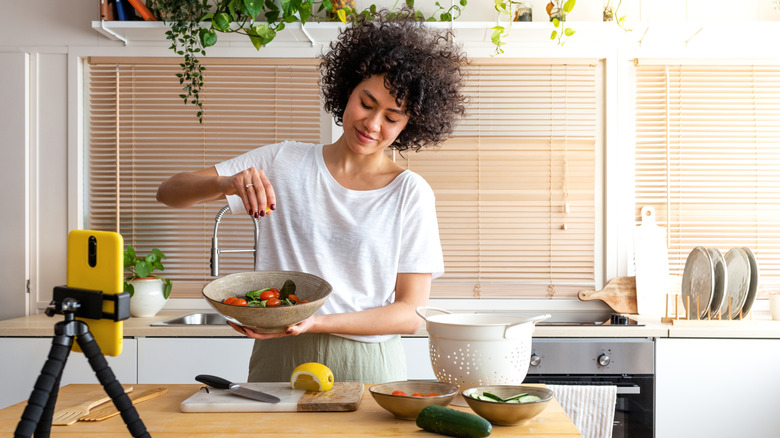Woman filming herself cooking