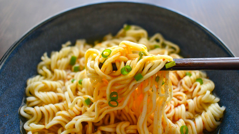 A plate of instant ramen noodles with scallions for added flavor