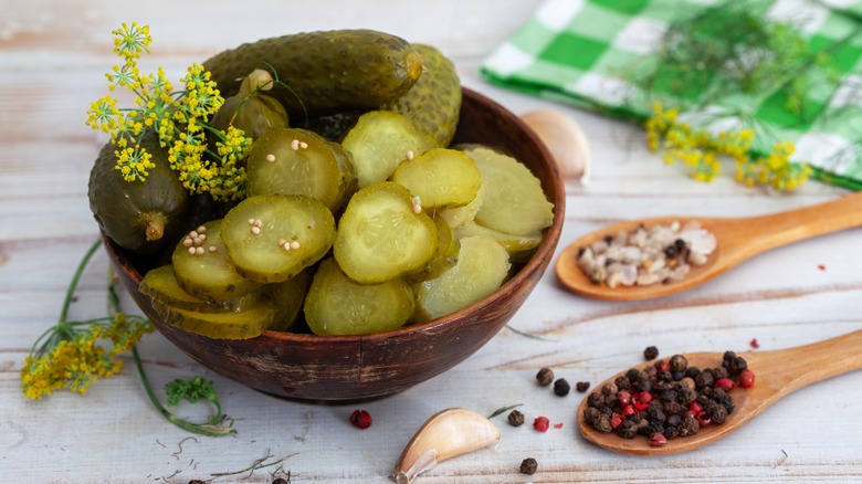 Bowl of Whole and Sliced Pickles with Spices