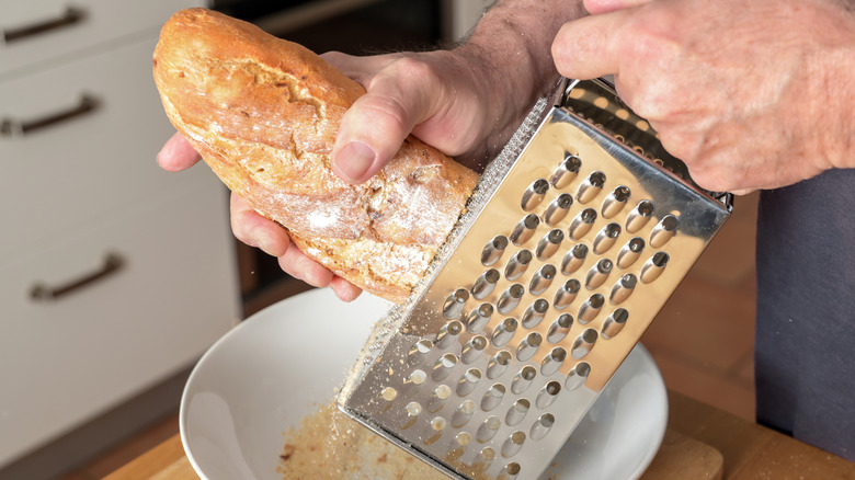 An illustrative image showing a man grating a piece of bread