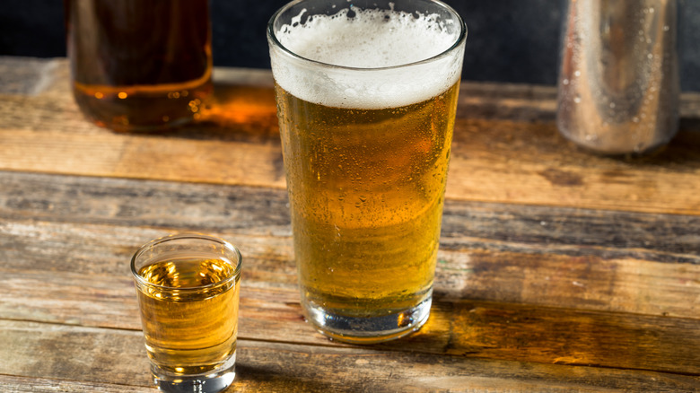 A beer and a shot of whiskey on a bar