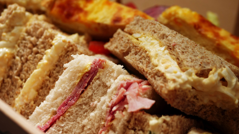 A closeup of a sandwich platter cut into triangles.