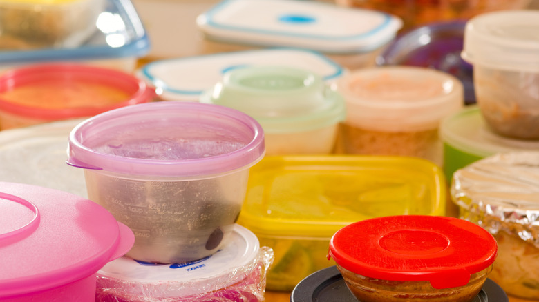 A couple of plastic containers with food arranged erratically