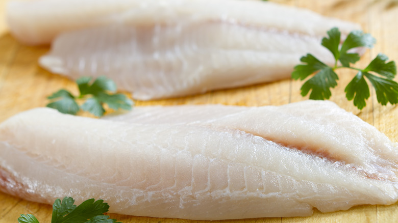 White fish filets on cutting board
