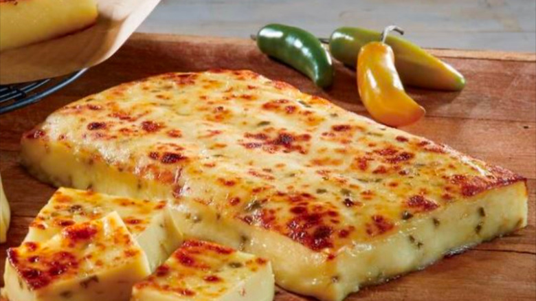 a close up of bread cheese on a wooden table