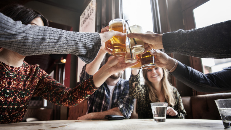 Group of people toasting with beer