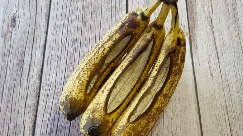 Three bananas with split peels
