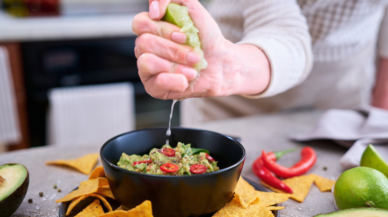 Squeezing lime juice into guacamole