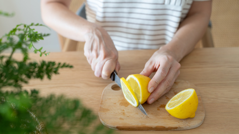 A person slicing lemons