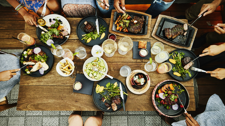 Overhead of large group dining at a wood table