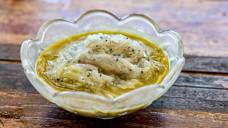Fish marinating in glass bowl