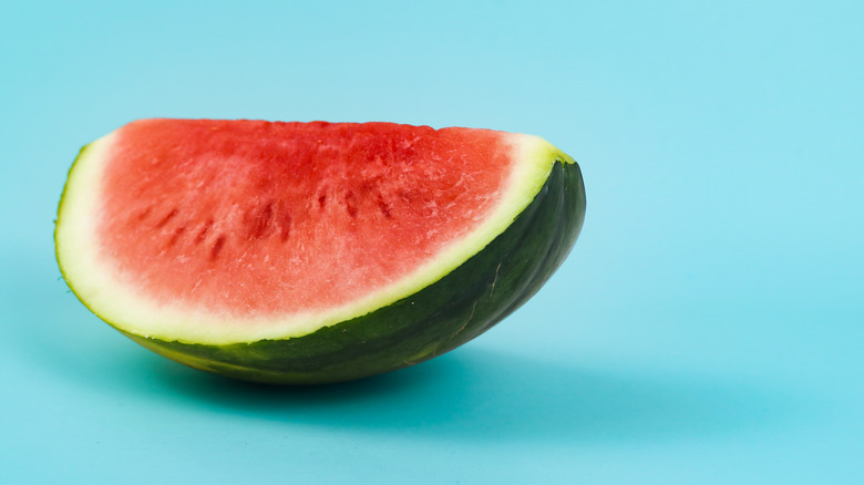 An illustrative image of a seedless watermelon slice on a blue background.