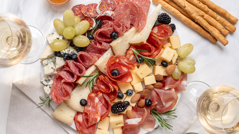 charcuterie board with salami, cheese, berries, grapes and more