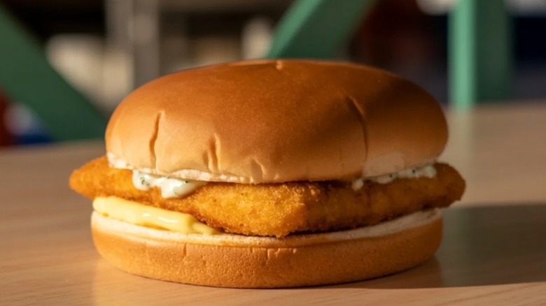 Fried fish sandwich on wood table