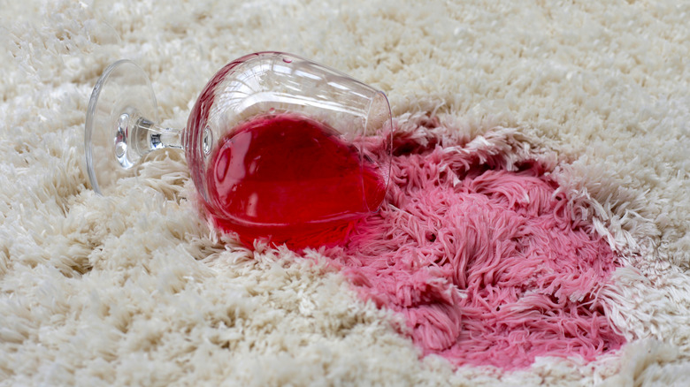 Red wine spilled on a white carpet.