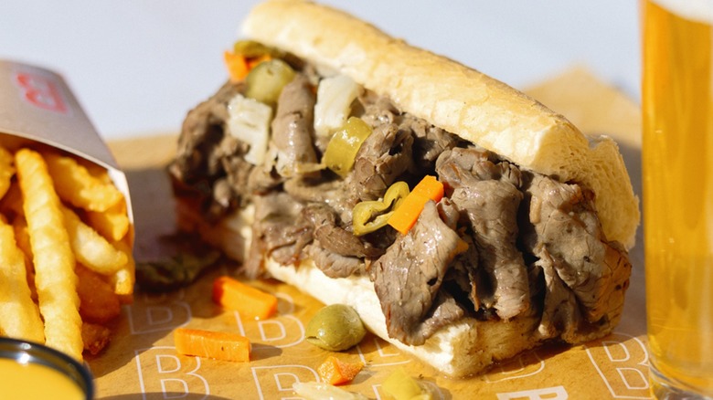An Italian beef sandwich with a side of fries from Buona Beef