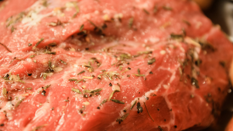 A raw beef steak with seasonings