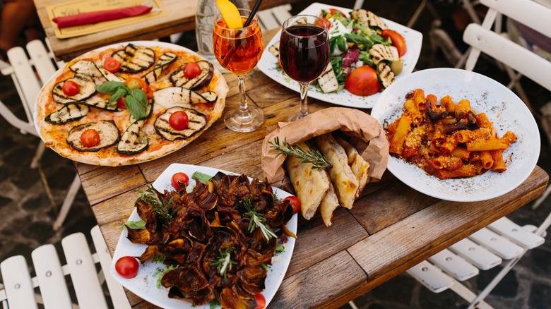 Plates of Italian dishes on an outdoor table