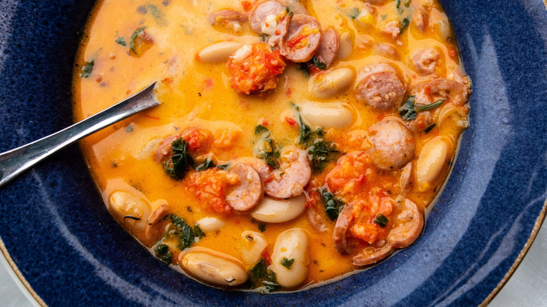 Top view of hot soup with butter beans and Italian sausage Salsiccia
