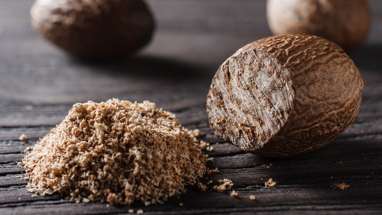 Ground nutmeg on wooden table