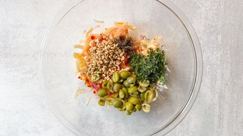 Italian-style tuna salad ingredients in large glass bowl
