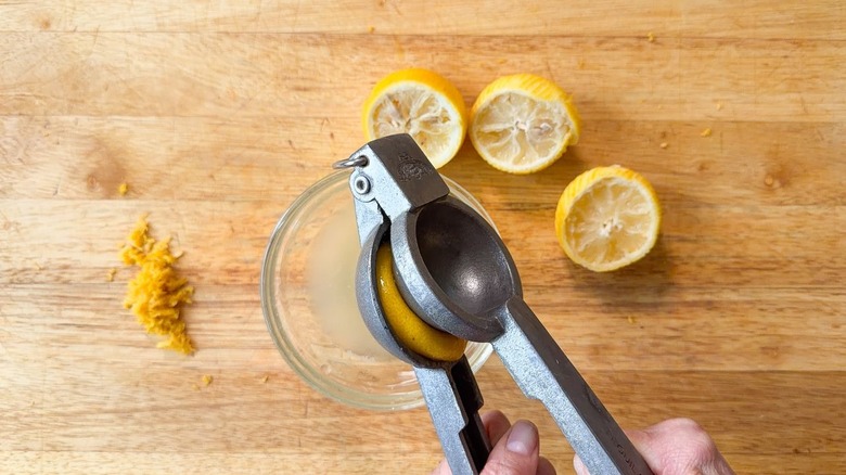 Juicing lemons over cutting board
