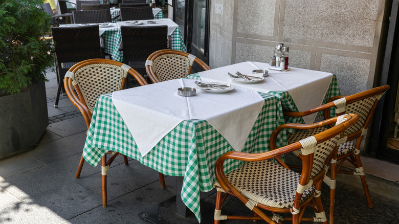 Charming al fresco dining in a trattoria lined with checkered tablecloth