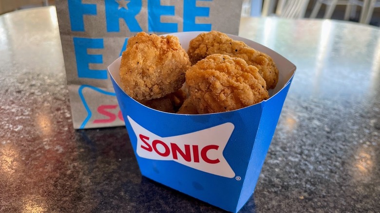 chicken bites in cardboard holder in front of Sonic bage