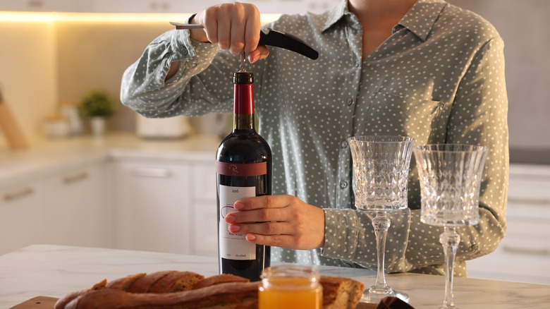 Opening wine with glasses