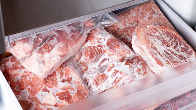 freezer drawer full of frozen meat