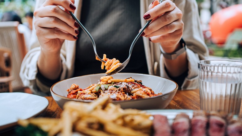 A restaurant diner twirling pasta on their fork