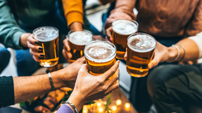 Friends toasting with pints of beer