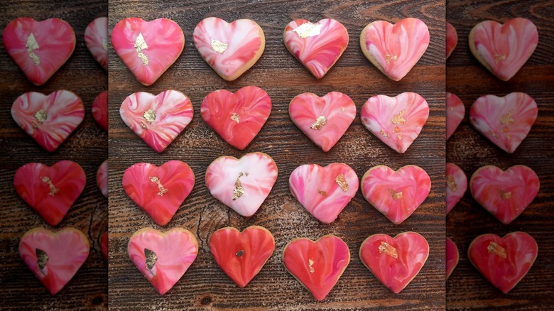Heart-shaped cookies topped with marble icing and edible gold