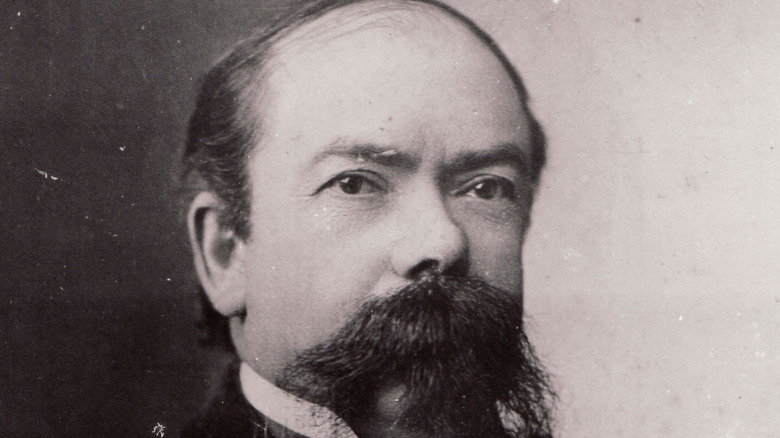 A historic photographic portrait of Jack Daniel.