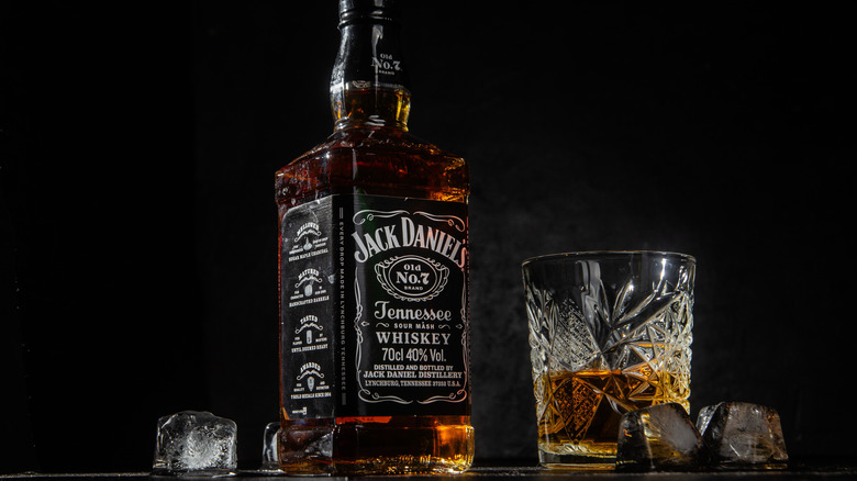 A bottle of Jack Daniel's Old No. 7 next to whiskey glass