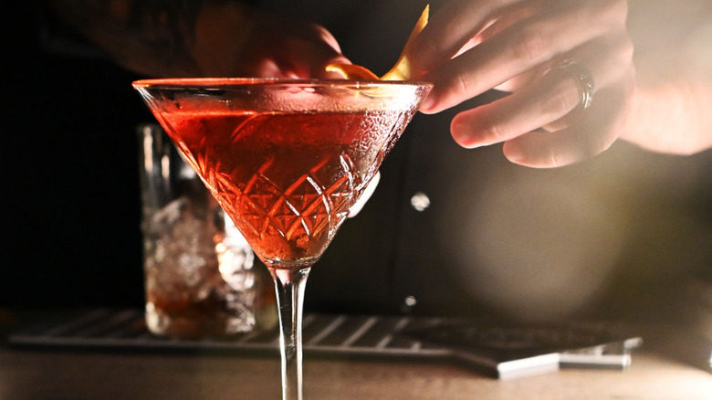 Close up of a bartender's hands making a reverse Manhattan