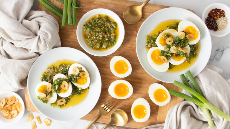 jammy eggs with scallion drizzle and crispy garlic plated