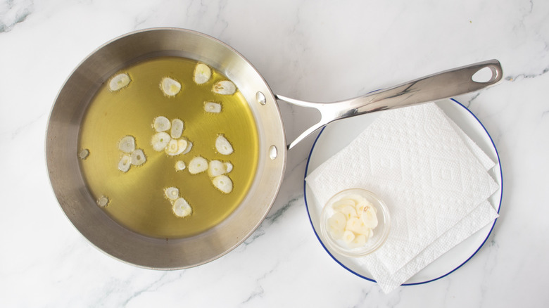 garlic slices in pan with oil