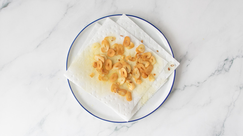 fried garlic slices on paper towels