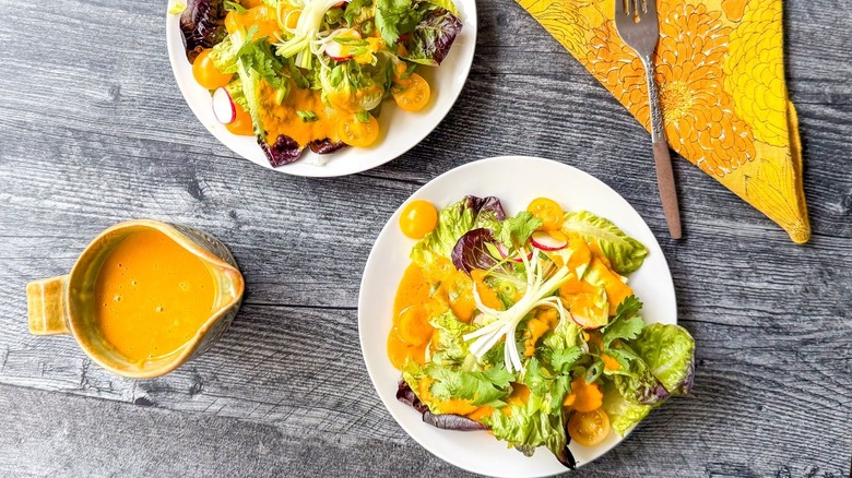 Japanese restaurant-style carrot ginger salads with pitcher of dressing