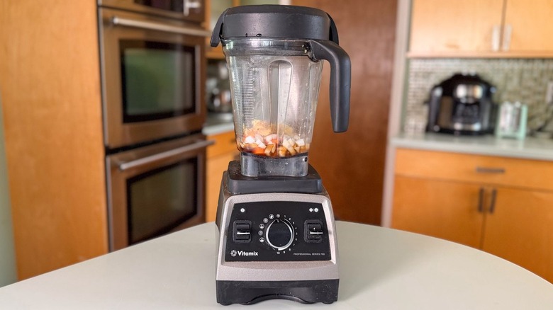 Carrot ginger dressing ingredients in blender on countertop