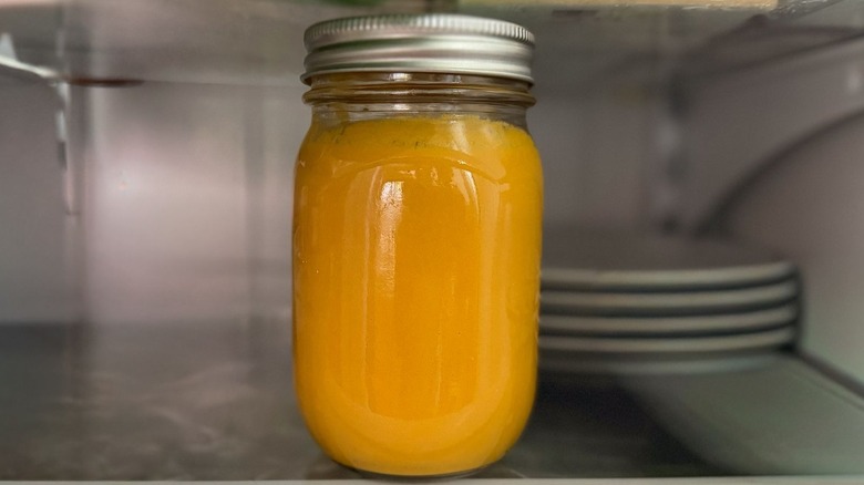 Carrot ginger dressing in mason jar in refrigerator